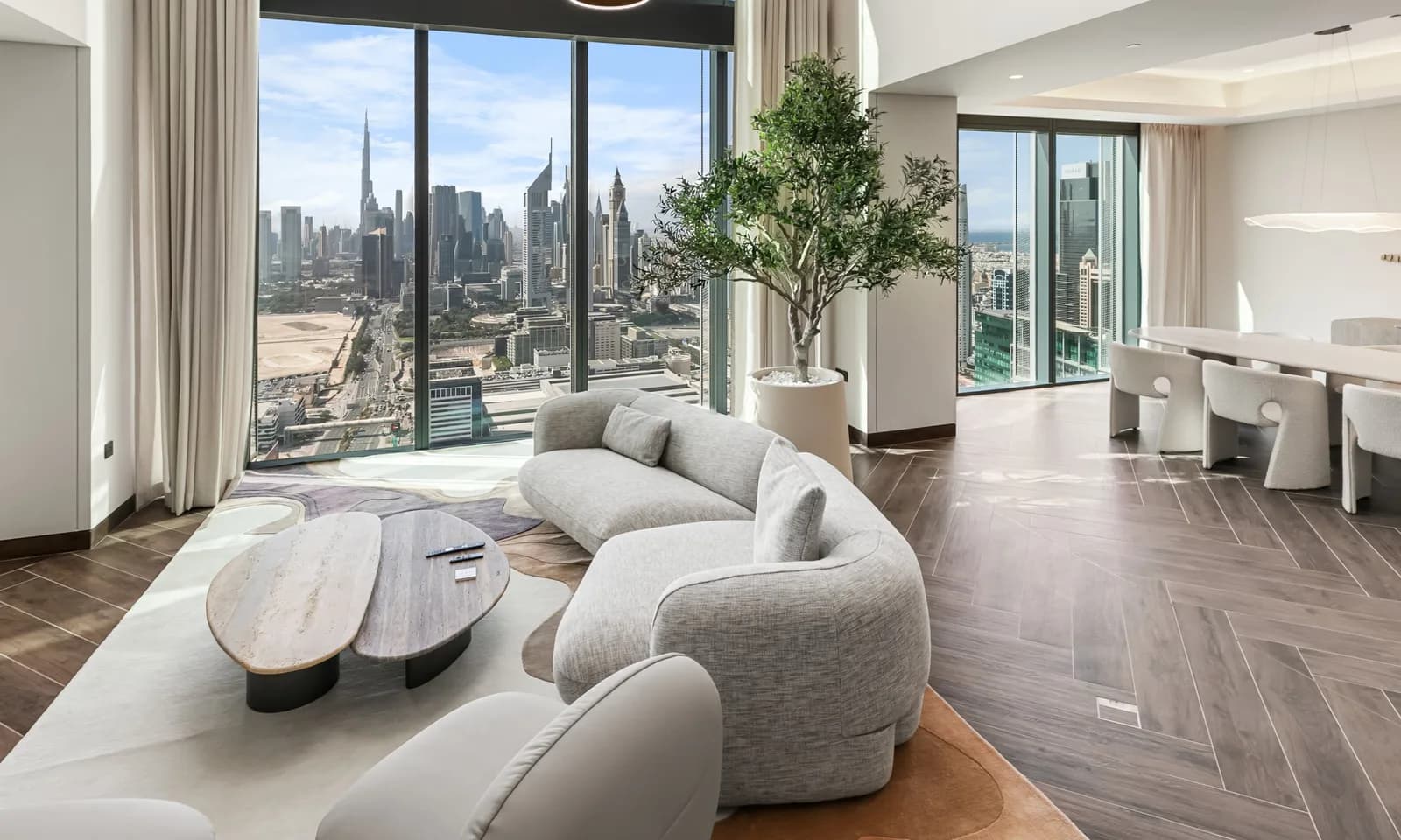 A double-height living room with Dubai skyline views in a home managed by Keys Please